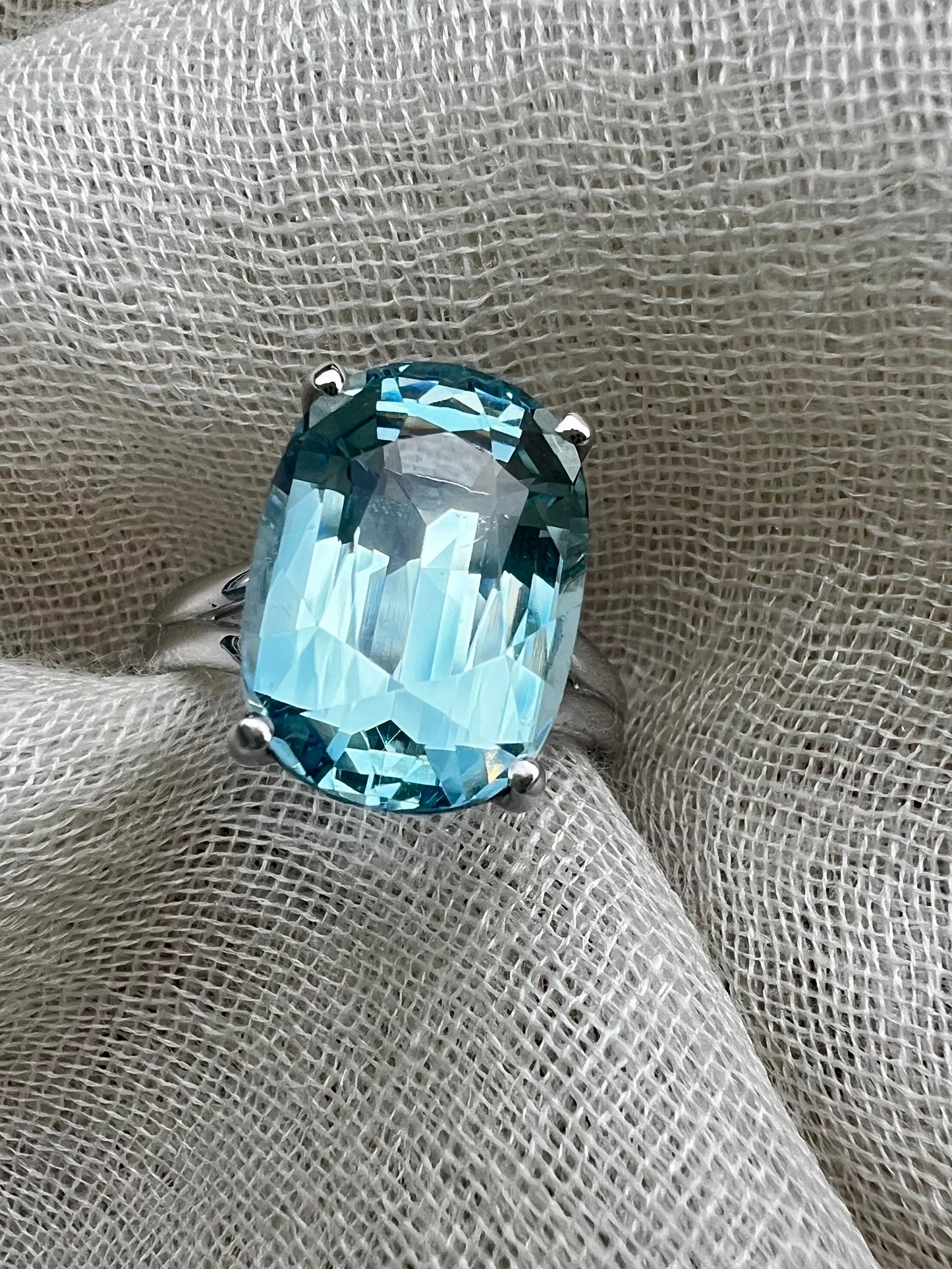 Cushion cut Aquamarine split shank ring in white gold.