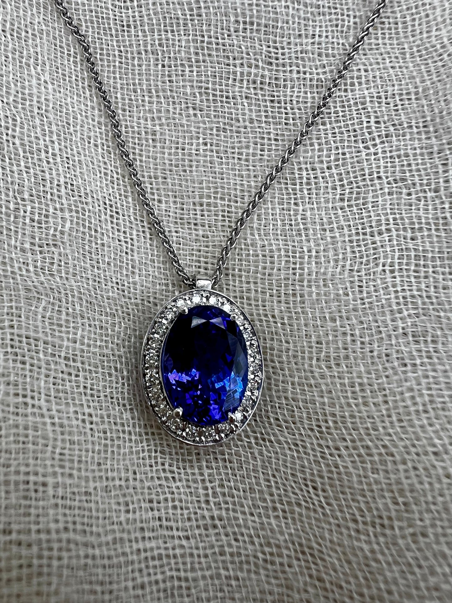Oval Tanzanite pendant with Halo of Diamonds.