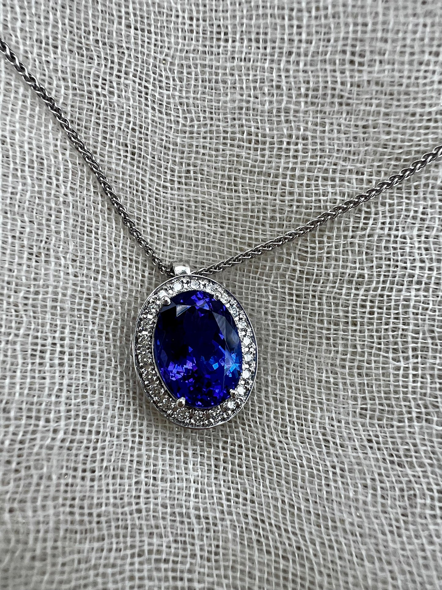 Oval Tanzanite pendant with Halo of Diamonds.