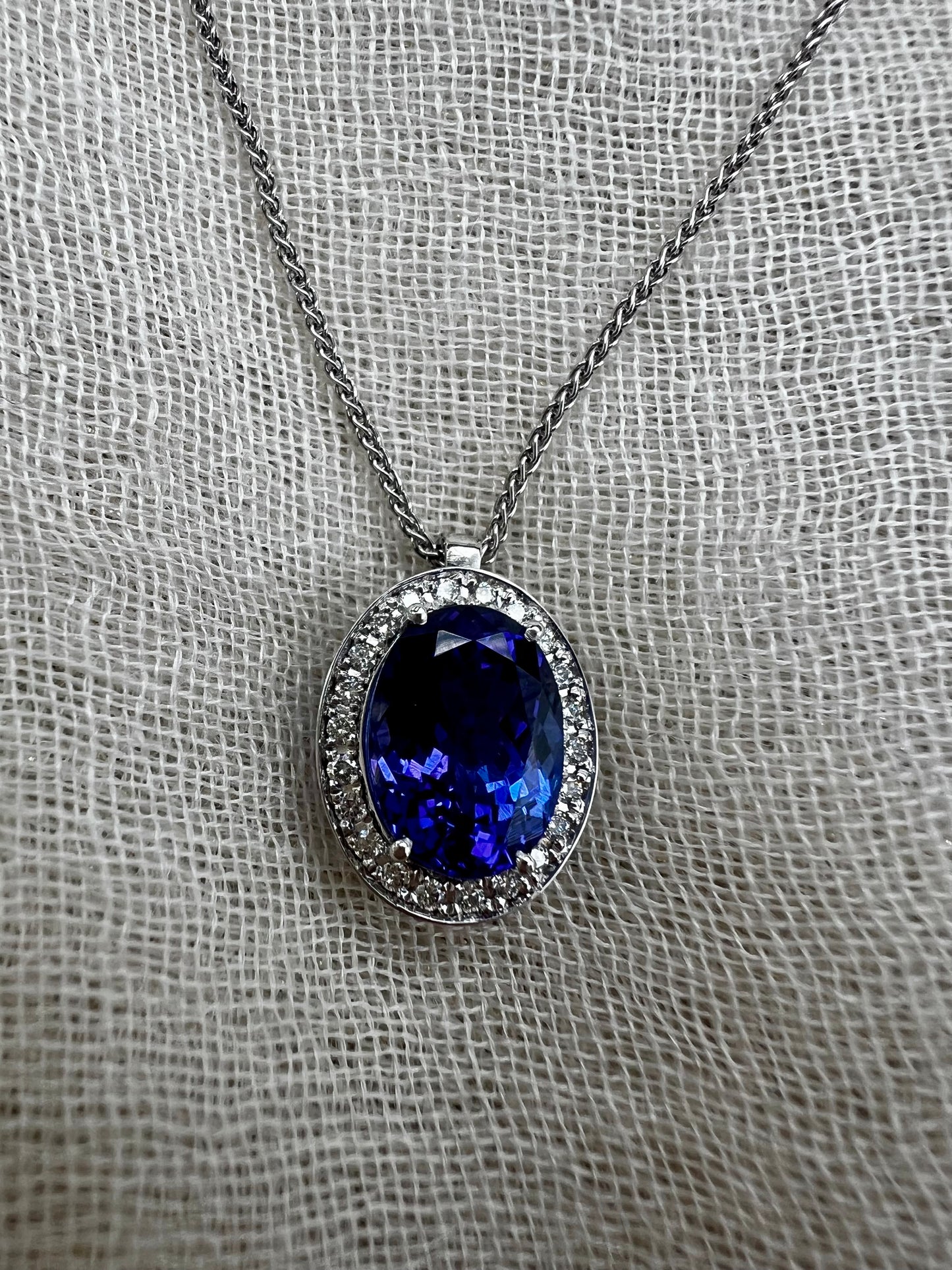 Oval Tanzanite pendant with Halo of Diamonds.