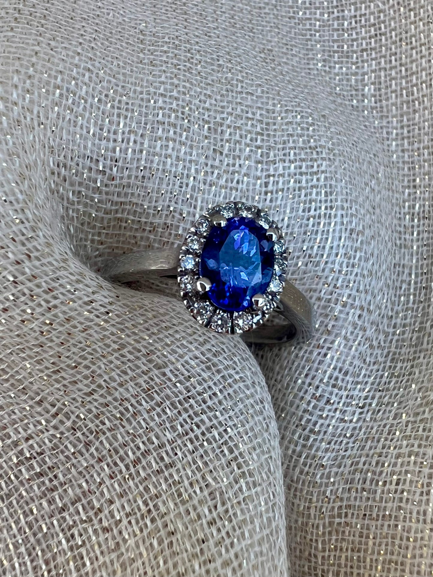 Tanzanite ring with halo of diamonds.