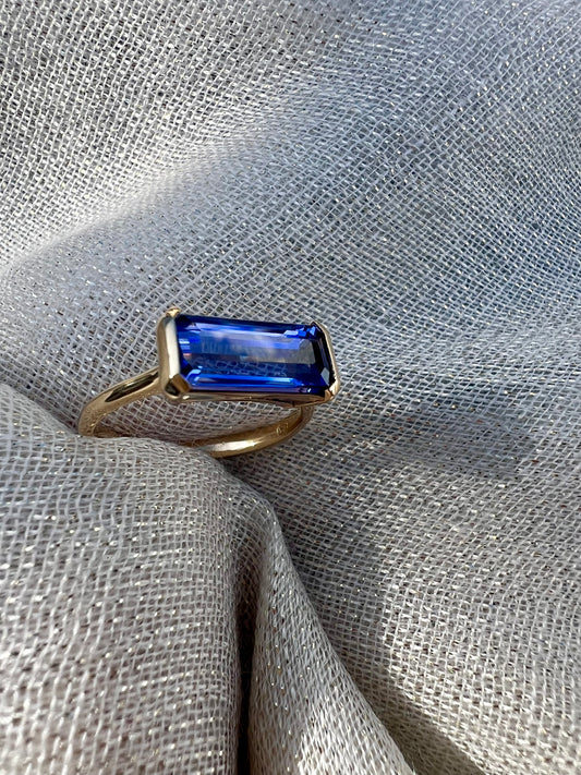 Tanzanite Emerald cut side set ring.
