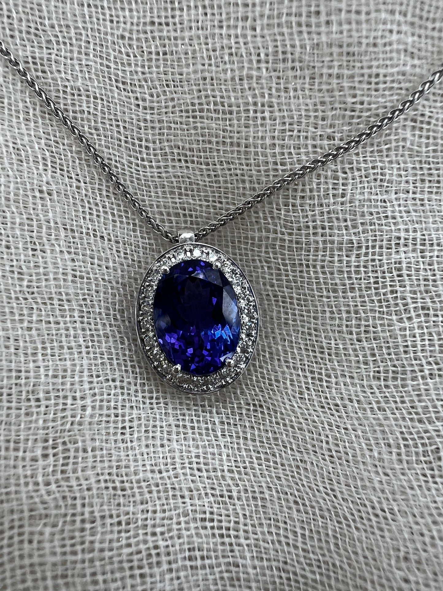 Oval Tanzanite pendant with Halo of Diamonds.